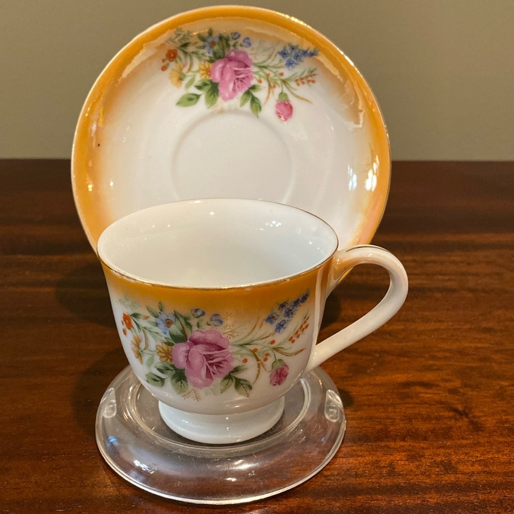 Vintage orange floral teacup and saucer set.